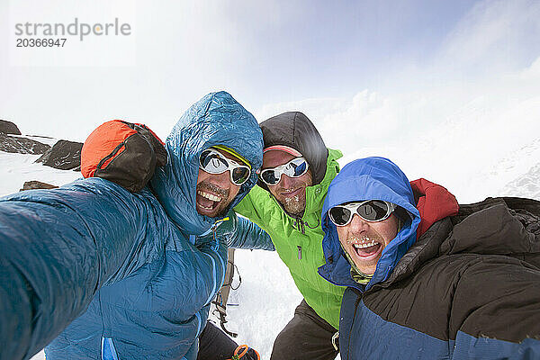 A Portrait Of Three Mountaineers On The Slopes Of Denali In Alaska