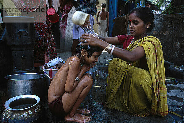 In Wohngebieten in Süd-/Zentral-Kalkutta  Indien  besuchen Frauen Röhrenbrunnen zum Baden  Waschen von Kleidung und zum Auffüllen von Wasser für Trink-/Haushaltszwecke.