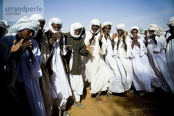 Shanabla men dance and chant at a wedding celebration near El Obeid  North Kordofan  Sudan. A nomadic tribe they raise camels.