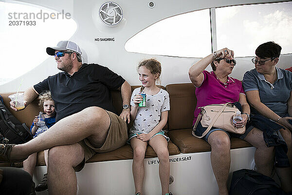 Large Family Sits Together on Open Air Caribbean Ferry
