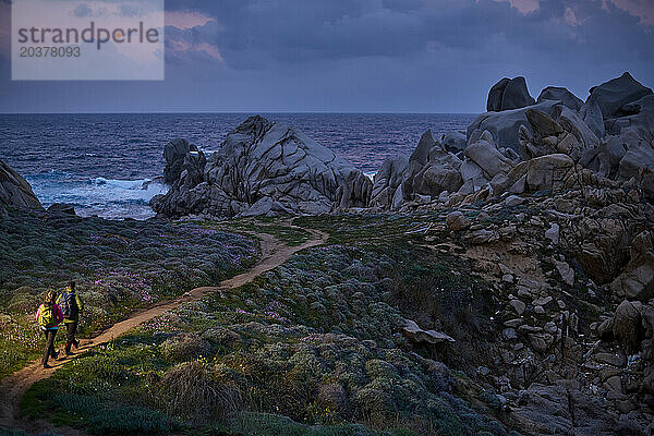 Blick auf ein Paar  das den Weg an der Küste entlang geht  Sardinien  Italien