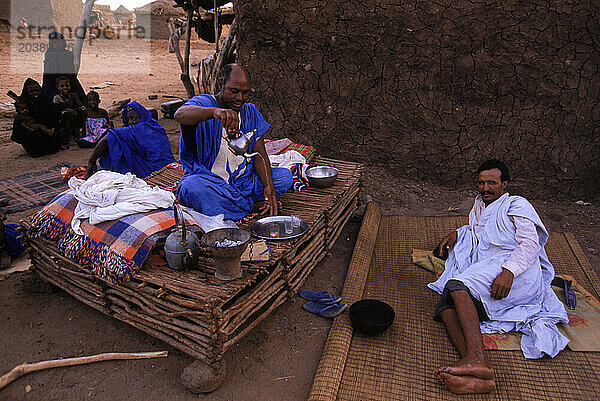 Men drink tea and relax in their huts in a Tuareg nomad camp near Timbuktu  West Africa.