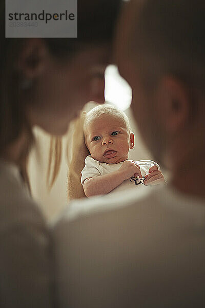 Baby boy with mother and father at home