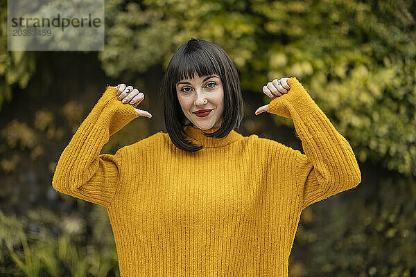 Woman with bangs wearing yellow sweater