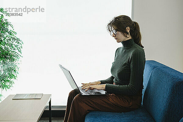 Businesswoman working on laptop in office