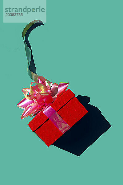 Red gift box against green background