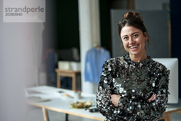 Happy beautiful businesswoman wearing sequin dress at home office