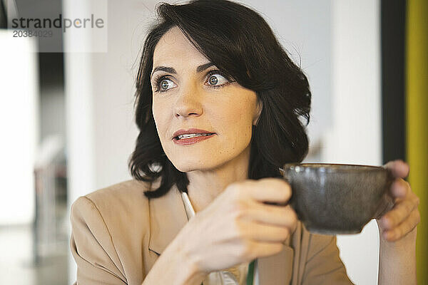 Businesswoman with coffee cup at cafe