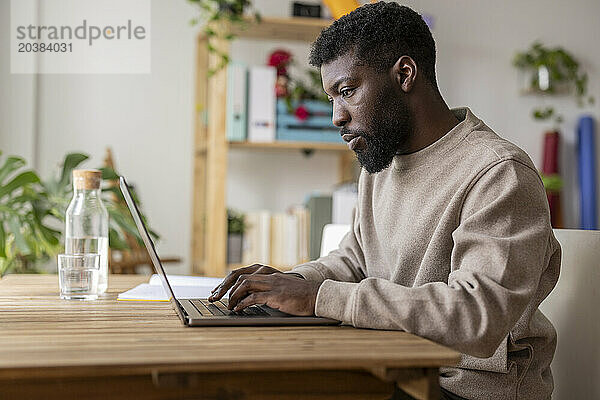 Freelancer working on laptop at home