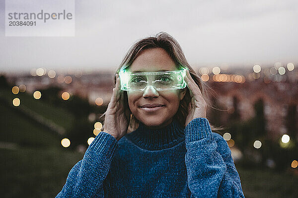 Smiling woman wearing illuminated smart glasses