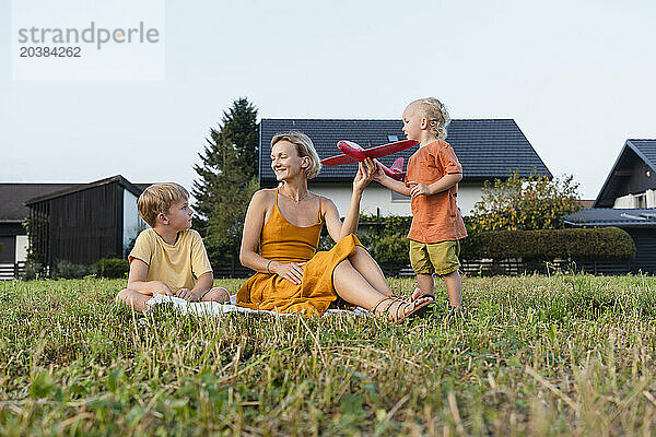 Mother playing with children in meadow