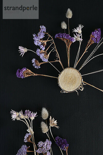 Studio shot of DIY decorations made of dried flowers and wood