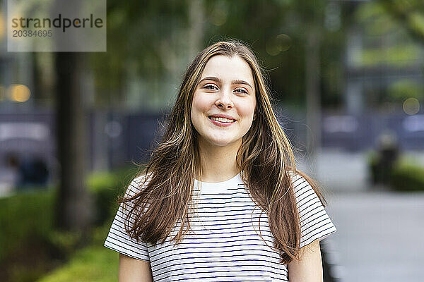 Smiling young woman wearing striped t-shirt