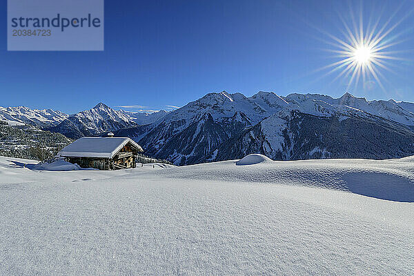 Snow covered cottage at Rastkogel near Zillertal Alps on sunny day  Tux Alps  Tyrol  Austria