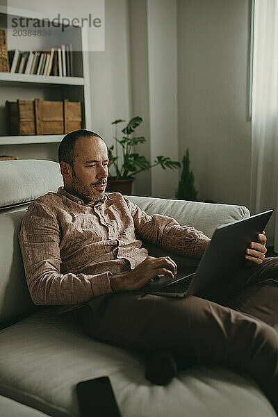 Freelancer working on laptop at home office