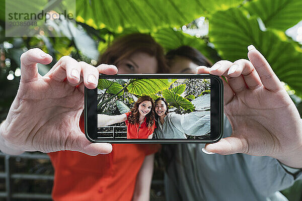 Friends taking selfie through smart phone