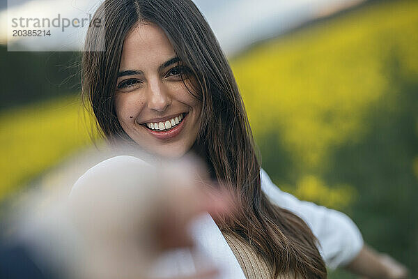 Happy young woman in field