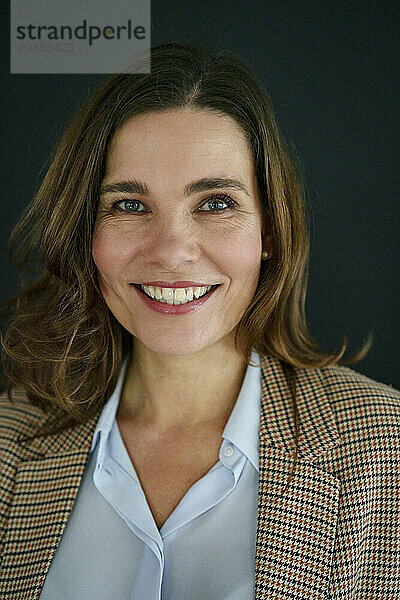 Smiling mature businesswoman in blazer