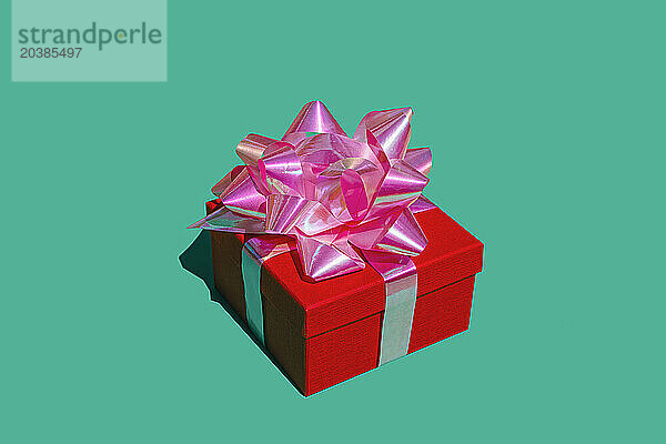 Red gift box against green background