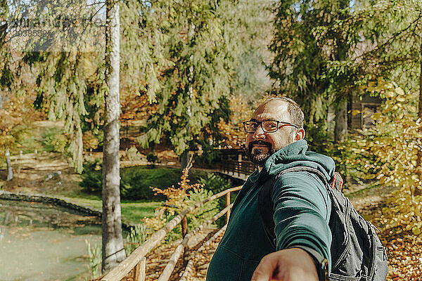 Hiker hiking in forest at sunny day