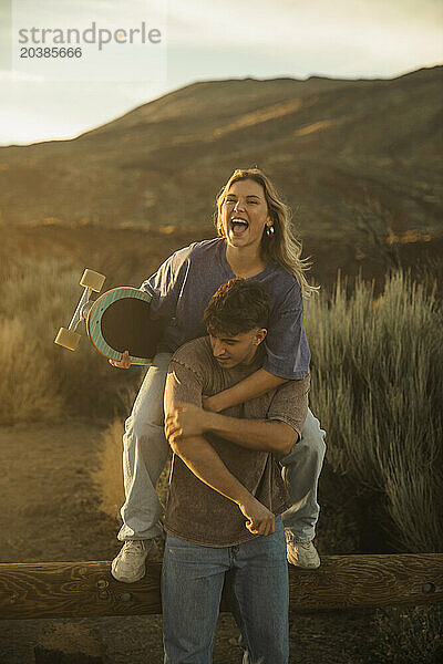 Man piggybacking girlfriend at Mount Teide national park