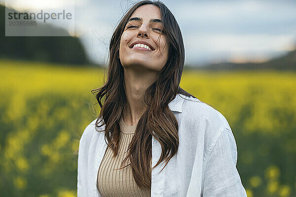 Happy young woman enjoying in field