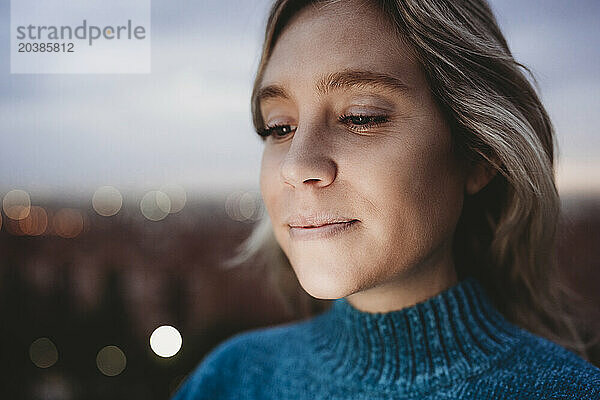 Face of smiling blond woman at dusk