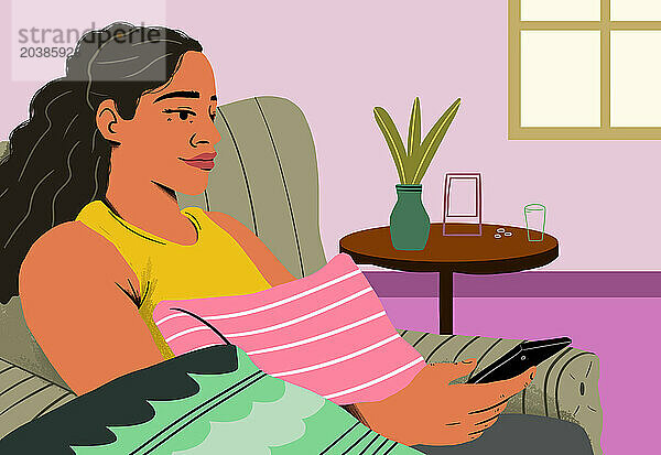 Woman using smart phone sitting on sofa at home