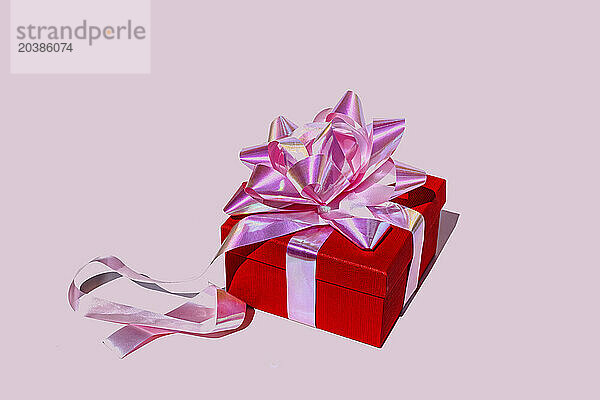 Red gift box against pink background