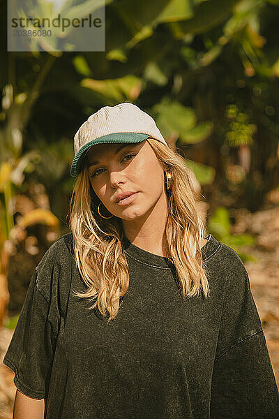 Beautiful woman wearing cap on sunny day