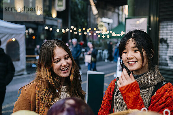 Happy sisters having fun on street