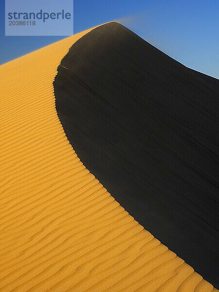 Sand dune under blue sky in Sahara desert  Egypt