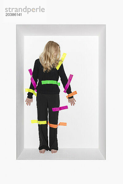 Blond teenage girl with colorful adhesive tapes stucked on body