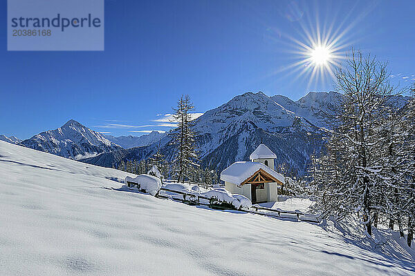 Snow covered Barbarakapelle near Zillertal Alps on sunny day  Rastkogel  Tux Alps  Tyrol  Austria
