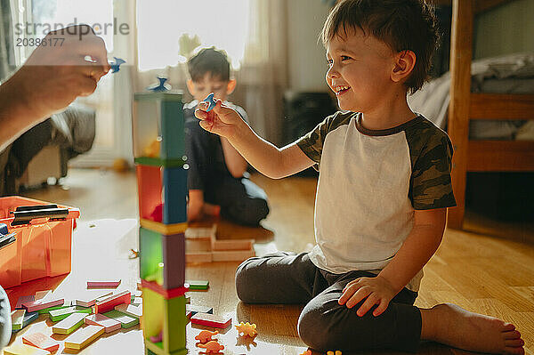 Smiling boy playing games with father at home