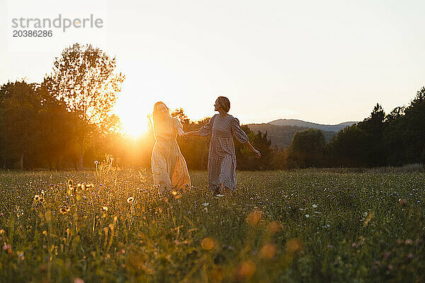 Friends spending leisure time walking in park