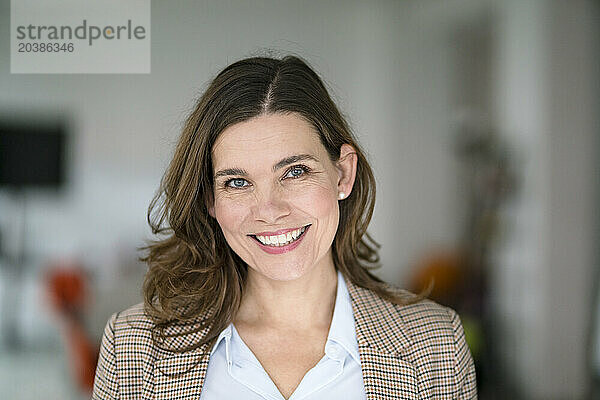 Smiling confident businesswoman in office