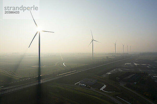Wind turbines in foggy farm at Netherlands