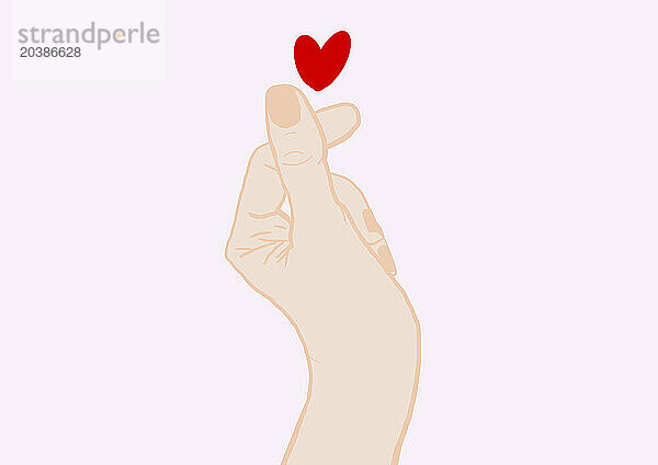Hand of woman making heart shape with fingers against pink background