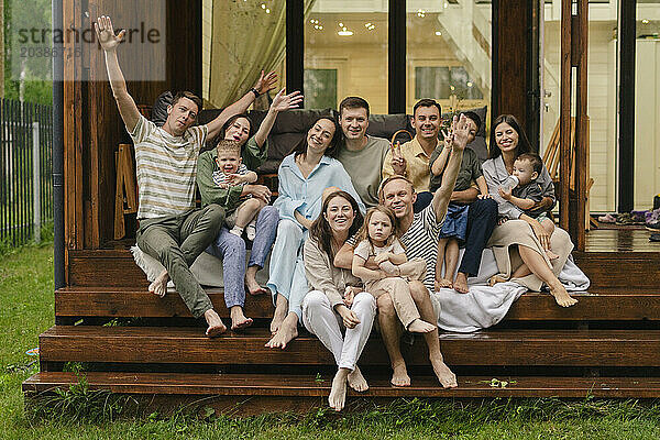 Cheerful friends and family spending leisure time together at house