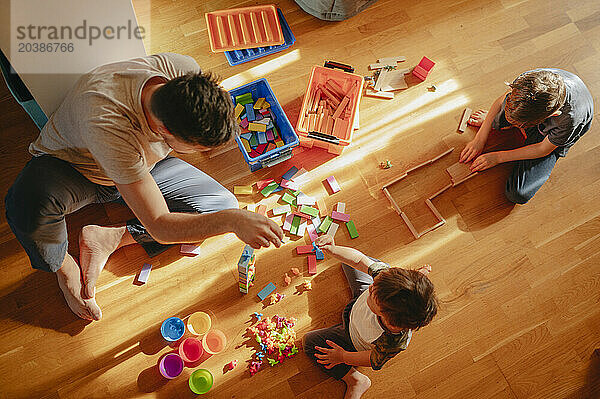 Children playing leisure games with father at home