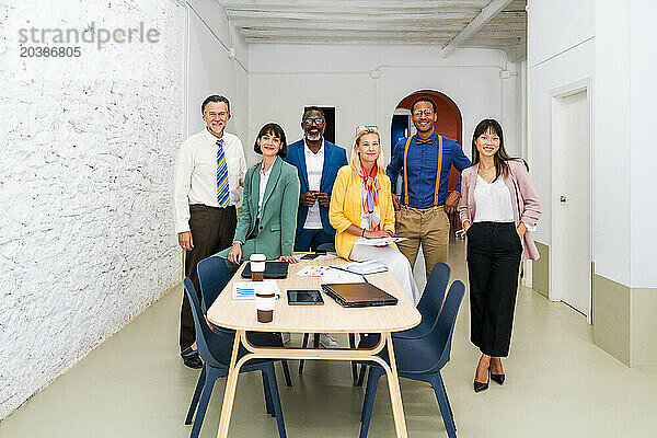 Confident multi-ethnic business colleagues posing together at office