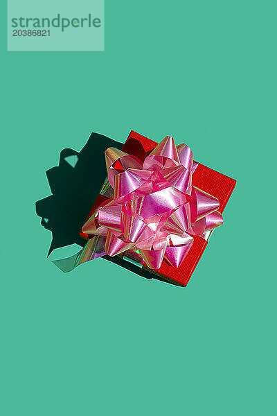 Red gift box against green background