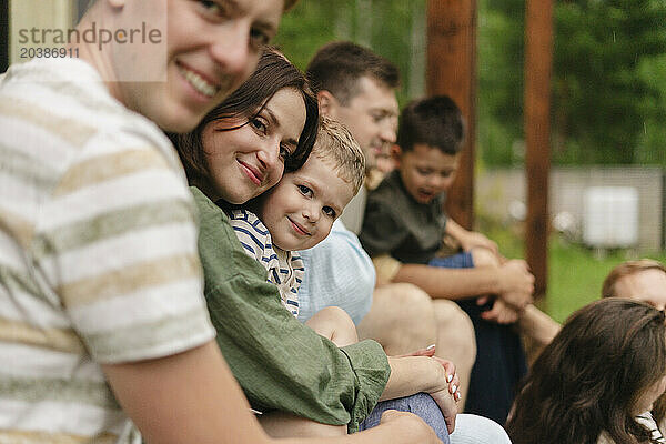 Happy family gathering with friends on summer vacation