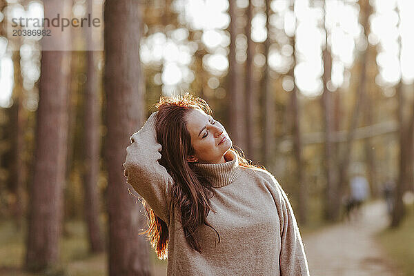 Mature woman with eyes closed standing in park