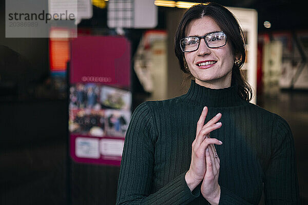 Smiling businesswoman wearing eyeglasses at cafe