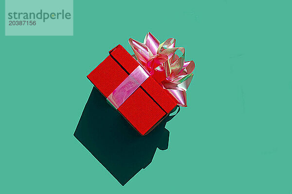 Red gift box against green background