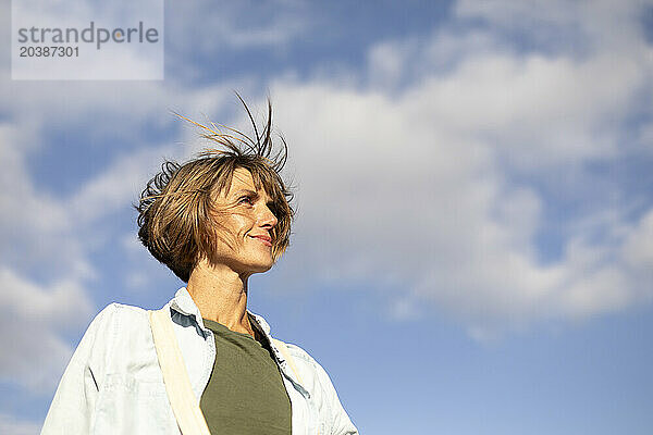 Woman with short hair under blue sky