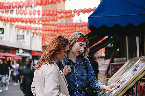 Friends looking at picture frames at store