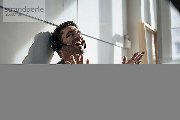 Cheerful mature businessman talking on headset